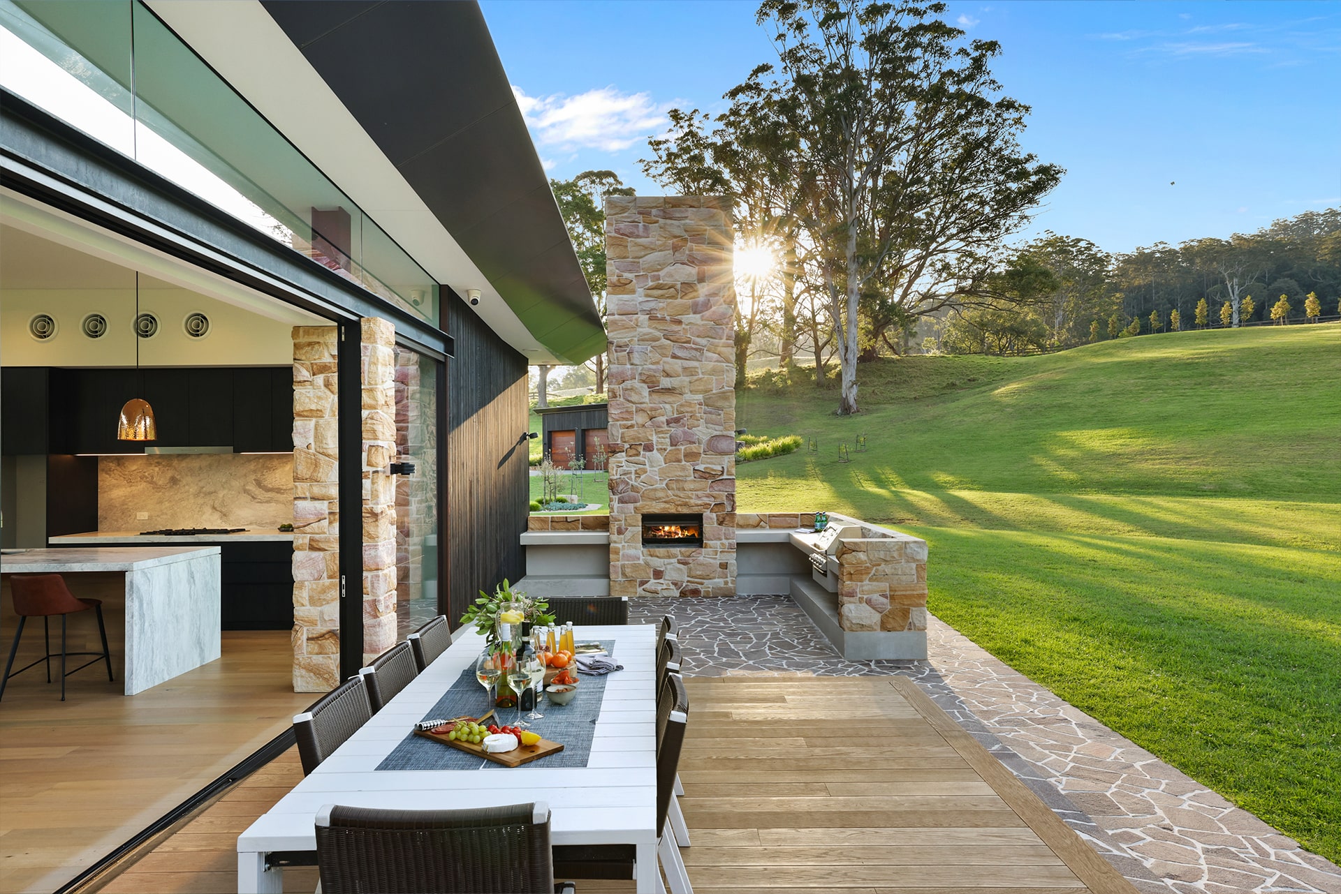 Outdoor dining and fireplace around composite deck