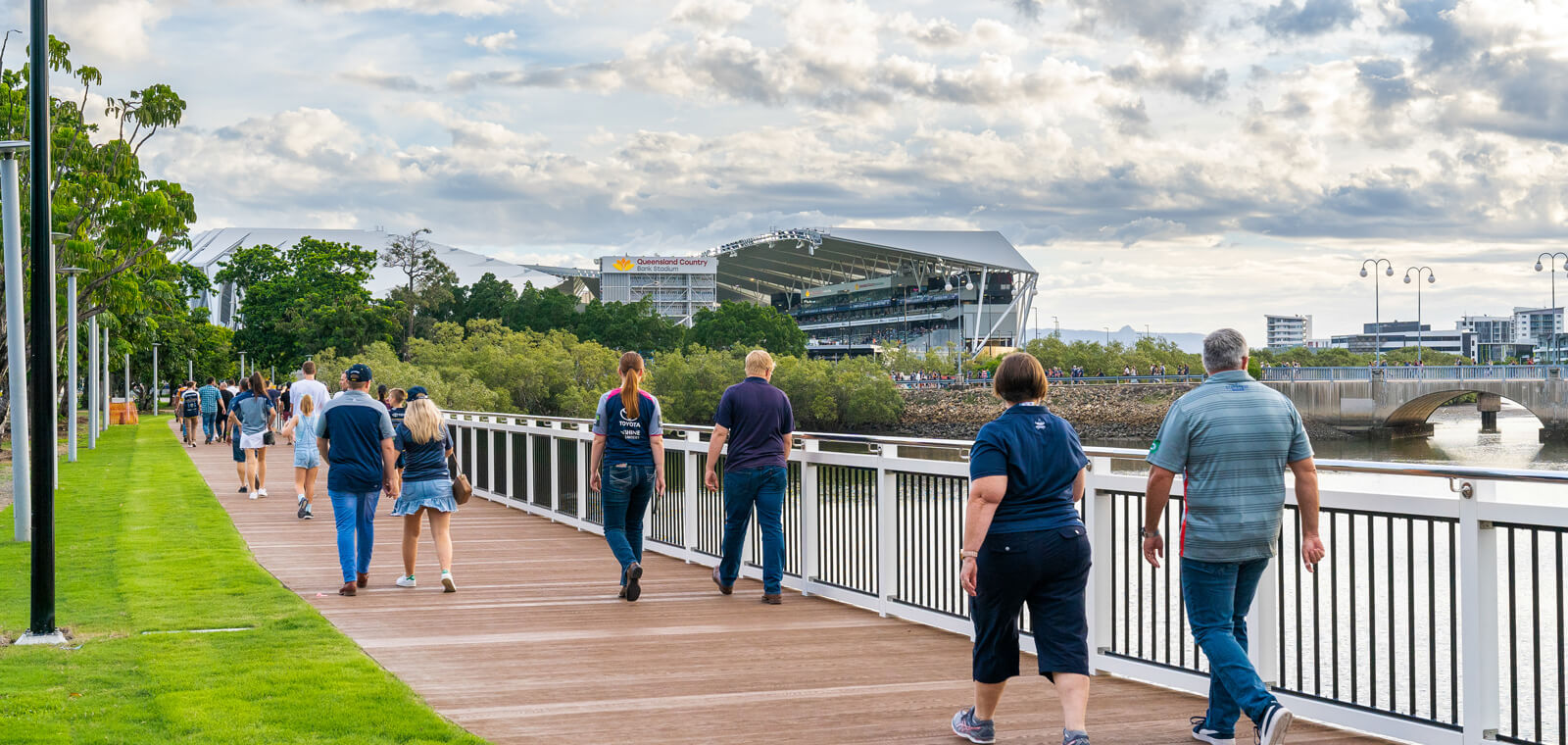 People walking to football match along Millboard boardwalk in Townsville